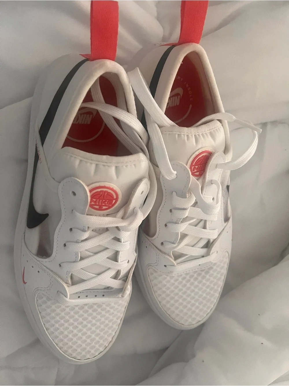 Nike Women’s White Athletic Shoes with Black Swoosh and Pink Accents